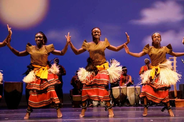 Dancers in striped wraps performing on stage