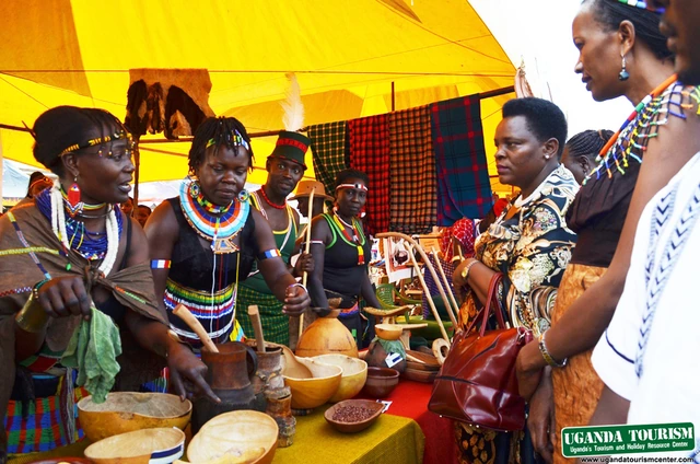 Women in traditional dress at a culture expo stall with crafts and food