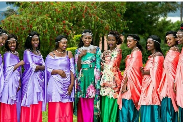 A group of women wearing brightly coloured traditional dresses