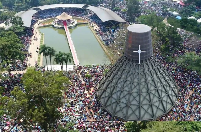 Pilgrims gathered around the lake at Namugongo