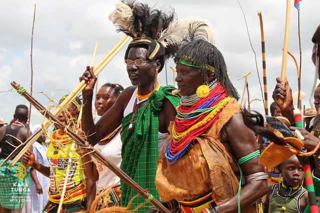 Dancers in beaded attire and feathered headdresses in northern Uganda