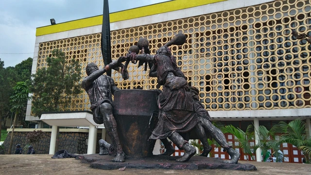 A bronze monument in front of the Uganda Museum building